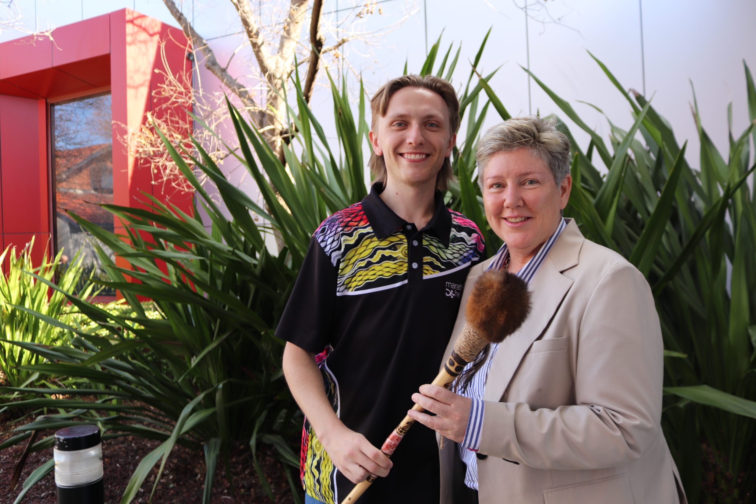 Jackson and Megan holding a message stick