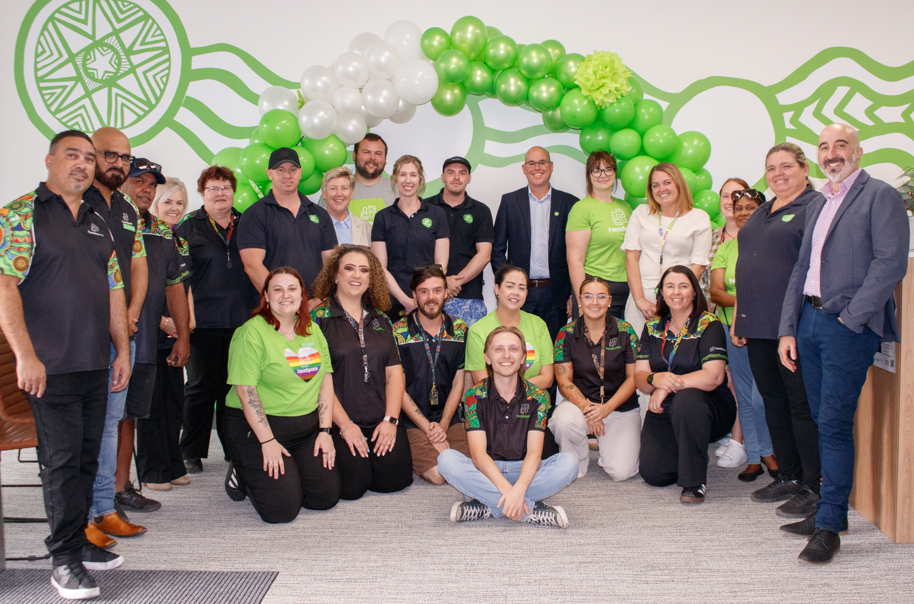 the headspace team and event attendees sit and stand smiling at the camera